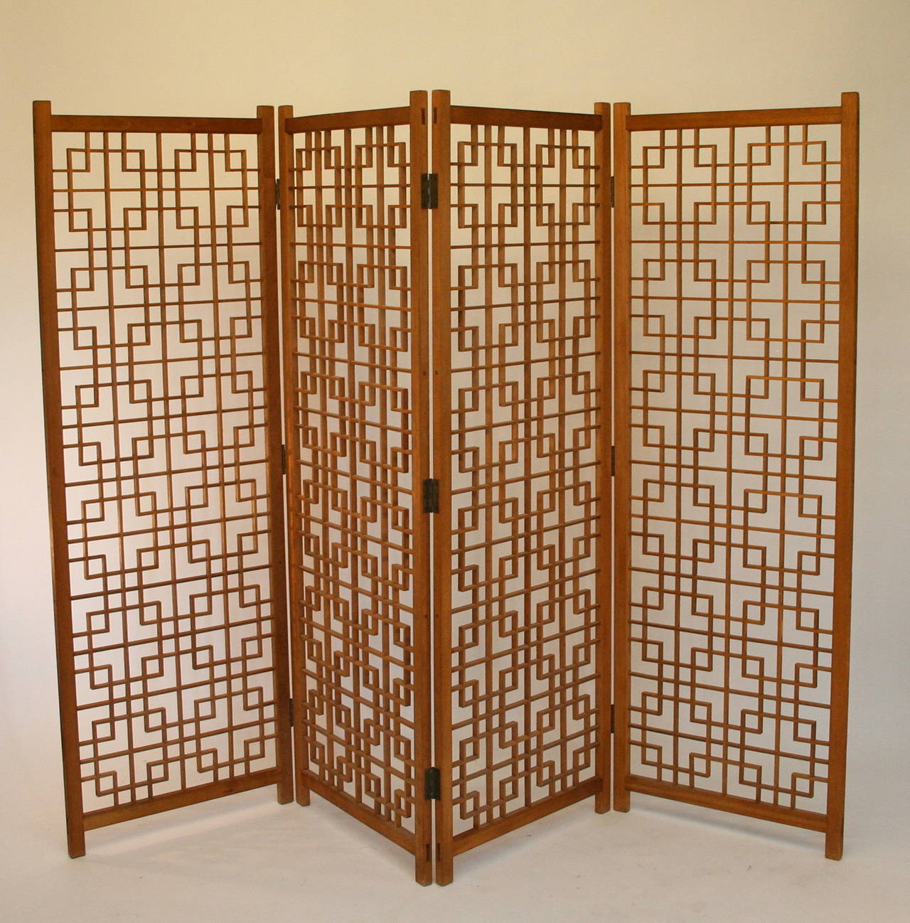 Four Panel Danish Modern Folding Screen/Room Divider.  Nice original condition (no missing pieces).  Solid teak condition with brass hinges.  Each panel is 23.5