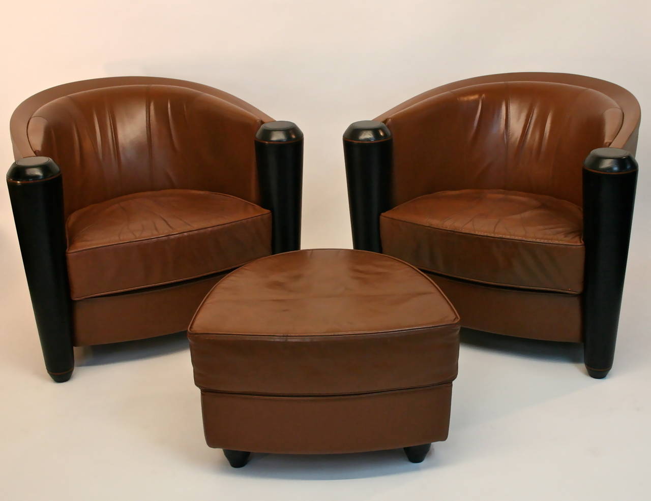 Pair of Italian leather Pace Collection club chairs and Ottomans. Designed by Adam Tihany. Manufactured by i4 Mariani. Chairs measure 39