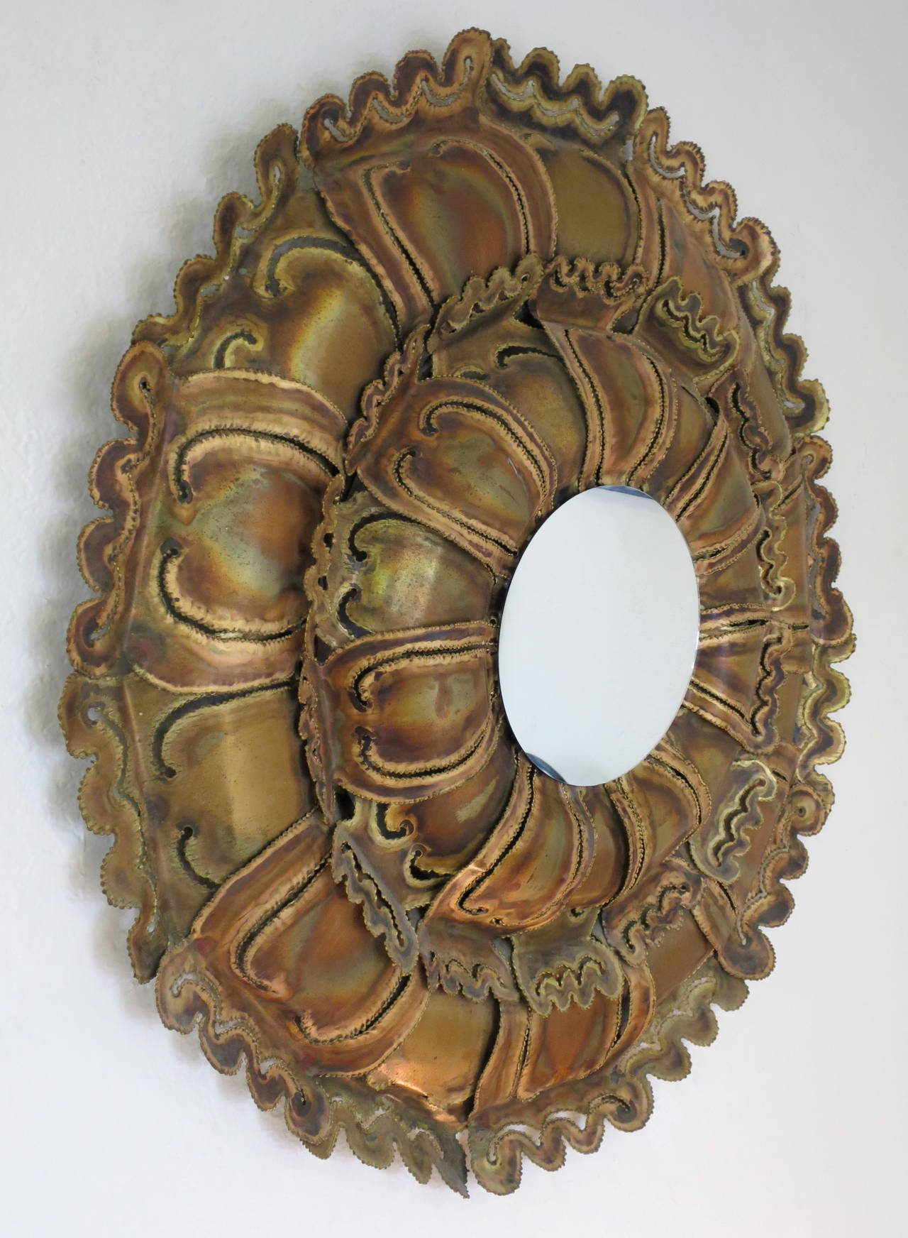 Torch cut brass Brutalist sunburst wall mirror. In the manner of Tom Greene, circa 1970s.