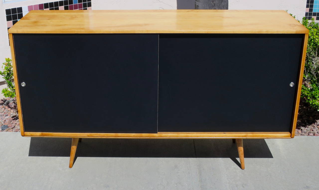 Solid maple credenza or sideboard by Paul McCobb. Manufactured by Winchendon, circa 1950s. Cabinet has been refinished and the doors have been replaced.