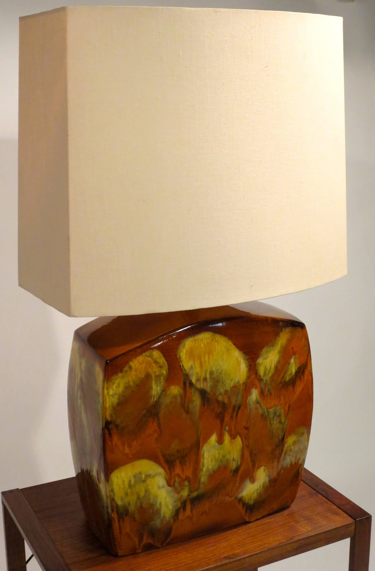 Large glazed ceramic table lamp. Original shade mirrors shape of lamp base. Excellent condition, circa 1970s. Lamp base measures 17