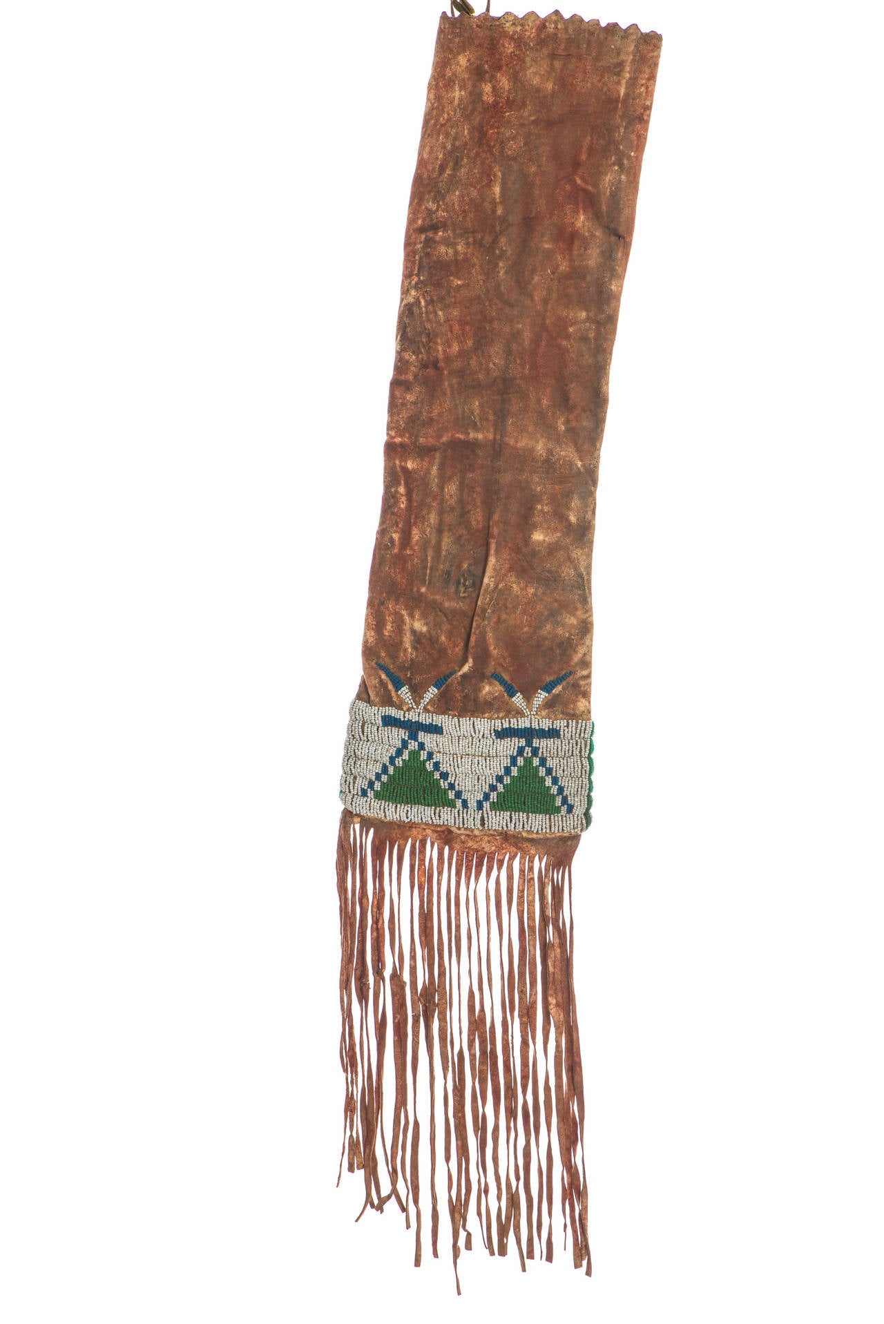Region/ tribe: Northern Plains / Assiniboine or Gros Ventre.

This pipe bag is completely ochre’d in deep red. The background colors alternate from side to side.

Materials: Native tanned hide, red ochre, seed beads (pony trader blue, green and