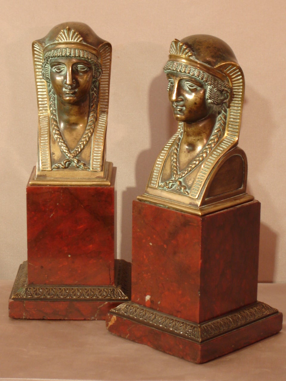 Attributed to Pierre- Philippe THOMIRE (1751-1843). Large pair of 'a l'Egyptienne' busts in gilded and patinated bronze. Paris. Empire period. 1800-1805. All resting on a cherry red marble rectangular base and a counter base also in cherry red