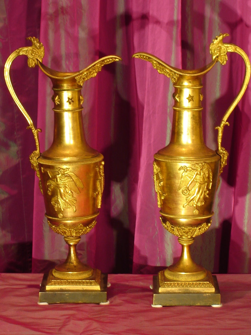 Exceptional pair of ewers in ormolu, dating from the early nineteenth century Empire period, attributed to Claude Galle (1759-1815), of baluster form resting on a pedestal decorated with figures draped in antique, musical attributes and palmettos,
