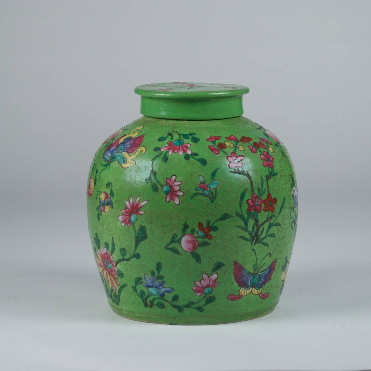 Handmade Chinese pot/vase made sometime in the late 18th-early 19th century. Beautifully hand-painted, with matching lid. This piece is eye catching and vibrant, with gorgeous details and colors.