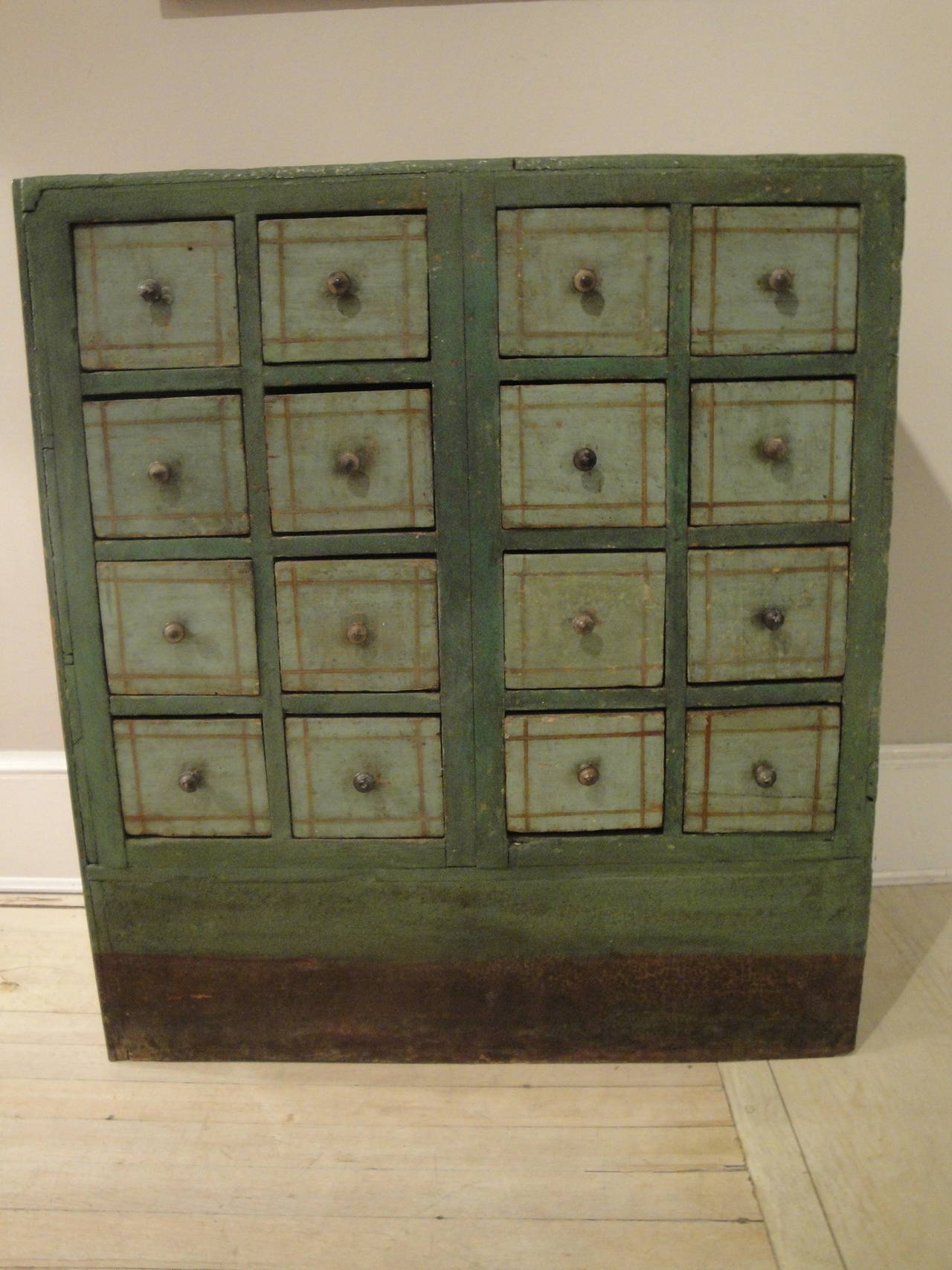 19th century French painted apothecary chest with 16 dovetailed drawers and original brass pulls.