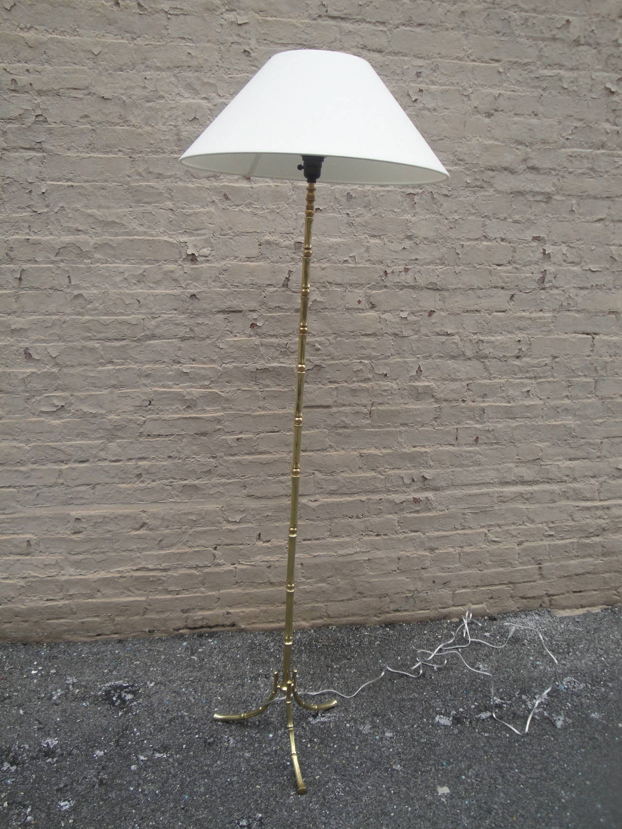 Mid-Century French brass bamboo motif floor lamp by Bagues with linen shade.