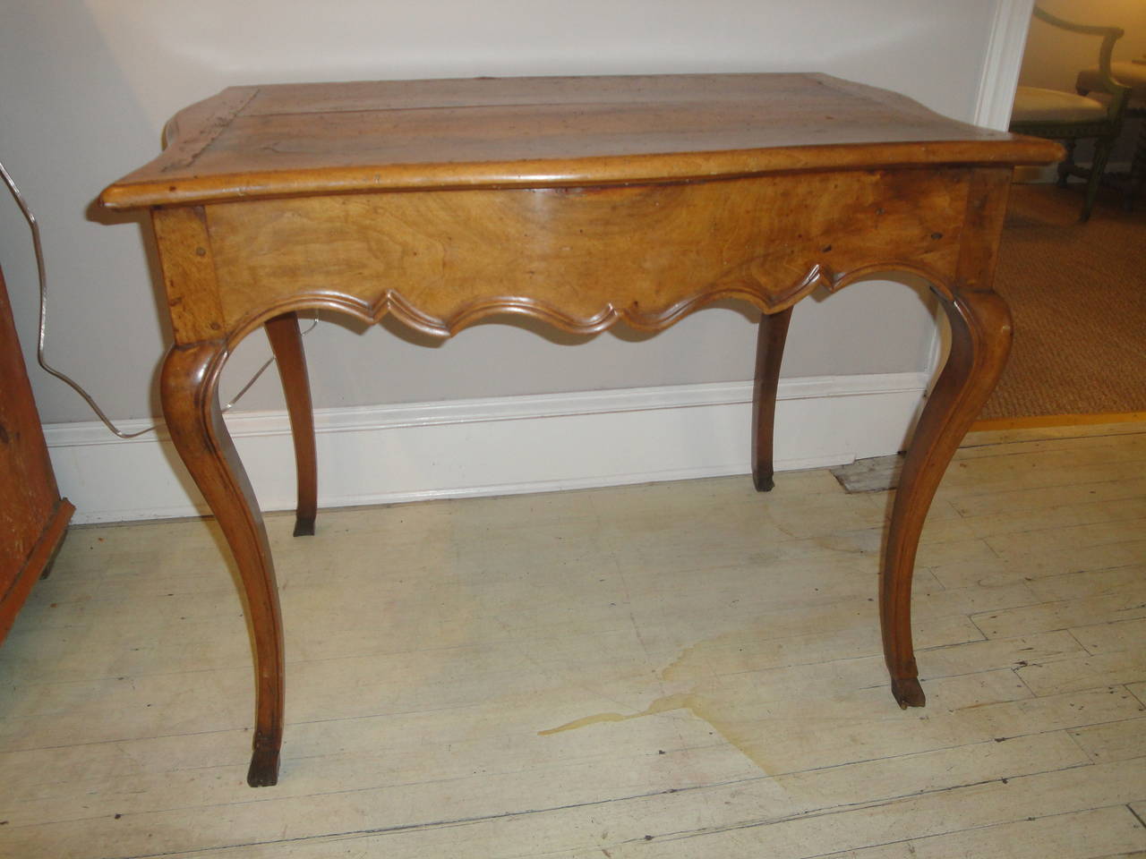 18th century French table milieu in walnut with two drawers, shaped apron and cabriole legs.