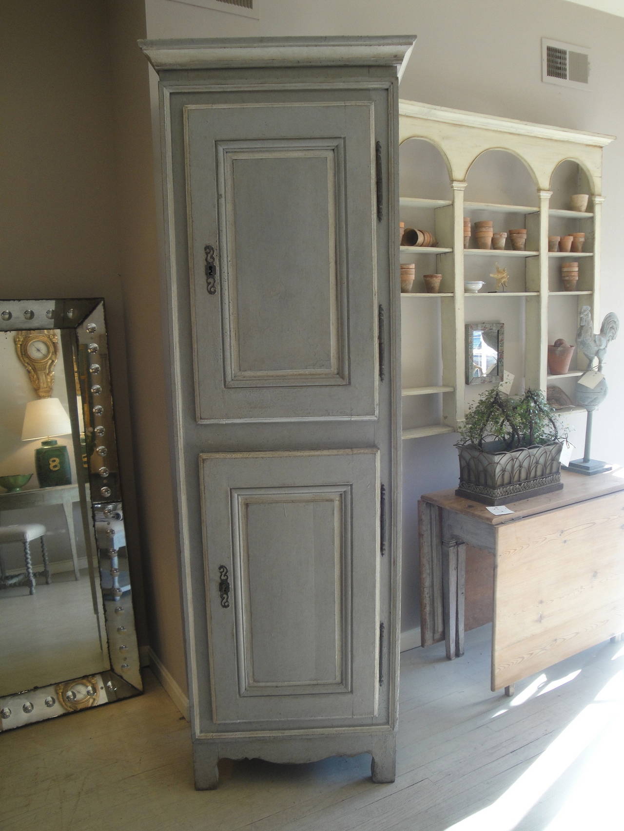 18th century French painted tall chimney cupboard with raised panel doors, shaped skirt and original hardware.