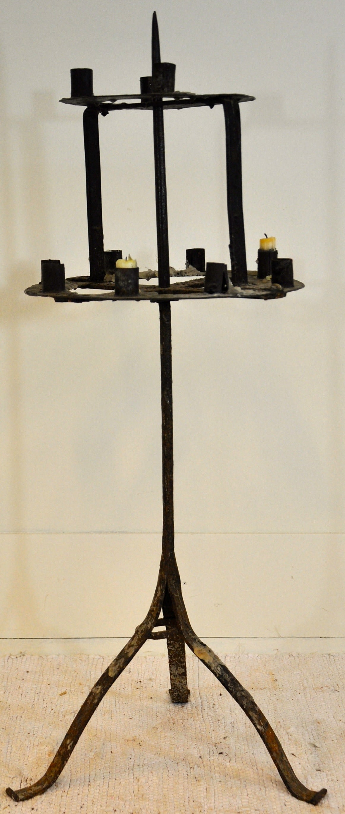 A French hand-forged iron candle Stand for ten candles, that can swivel two around
the central upright axe. A rustic and charming piece of work from the mountains in France.