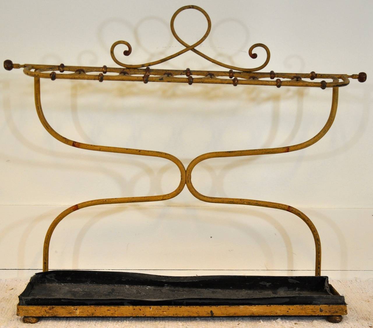 A French 19th century umbrella stand painted in a ocher yellow color.