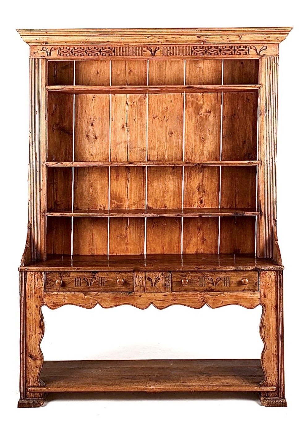 A charming provincial piece, an Irish version of the more commonly seen Welsh dresser, dating to the late 18th/early 19th century. In two pieces, the upper section with three fixed shelves, the bottom, with two drawers, both sections with relief