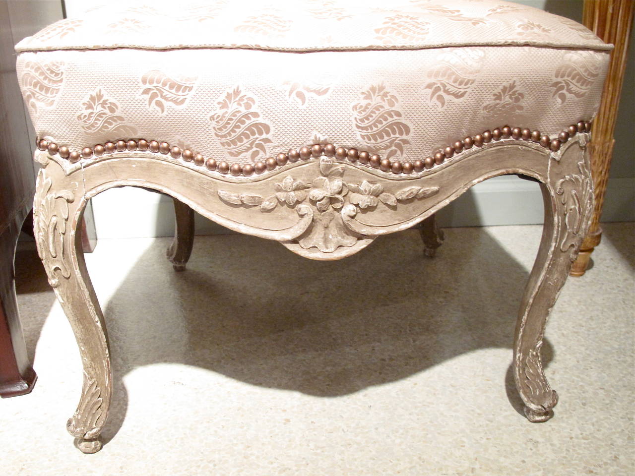 A fine rococo style carved beechwood chair, mid 19th century, with cabriole legs and curved lines, nicely carved throughout, painted grey over gesso. Freshly upholstered in silk. Very comfortable.