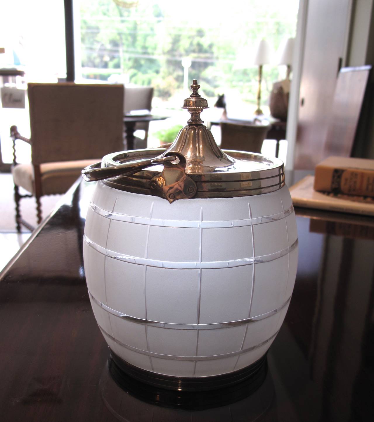 Of cut and frosted glass, in a barrel shape, with finely delineated and finished silver plate handle fittings and lid.