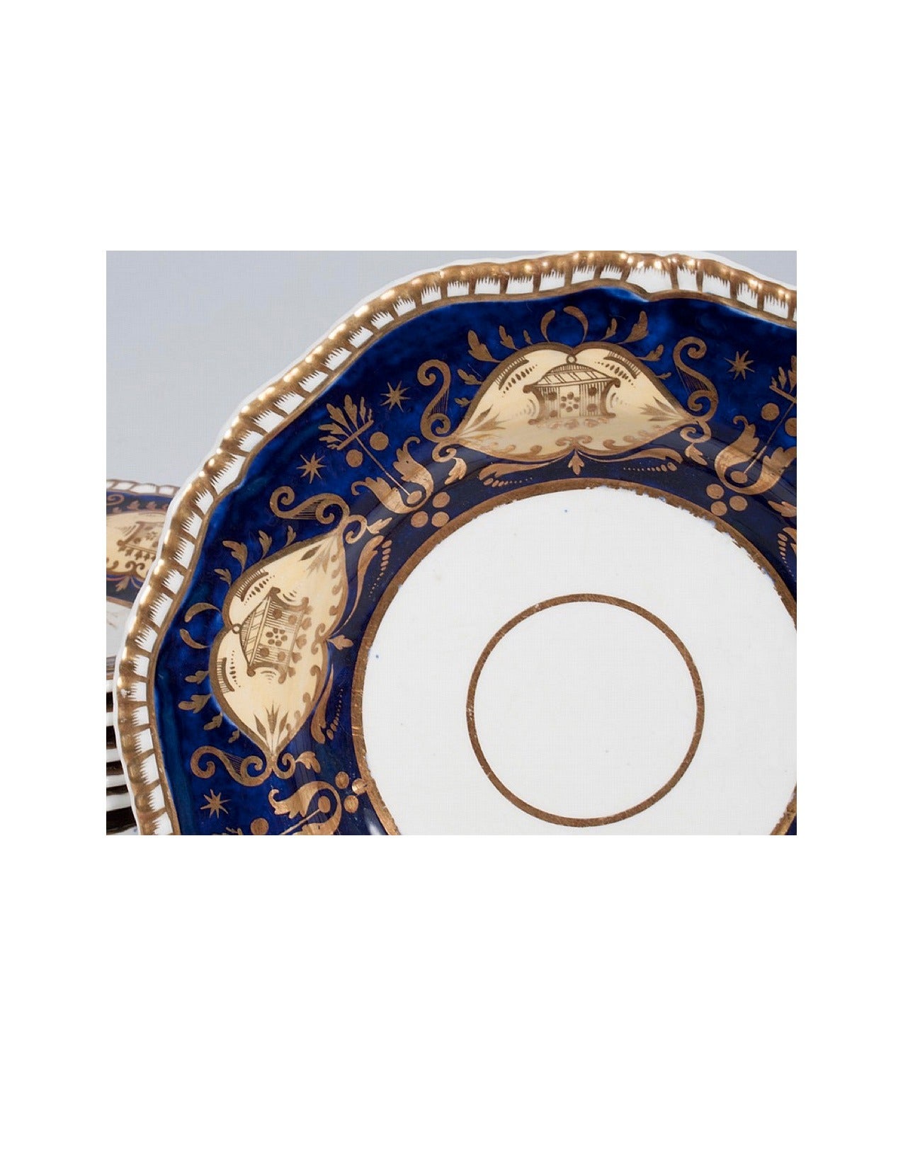 Thirteen pieces of beautifully decorated ca. 1820 set of deep dessert plates or shallow soup bowls with serpentine moulded gadrooned edges bordering the translucent cobalt glazed rims decorated with very fine Neoclassical ornament and colored