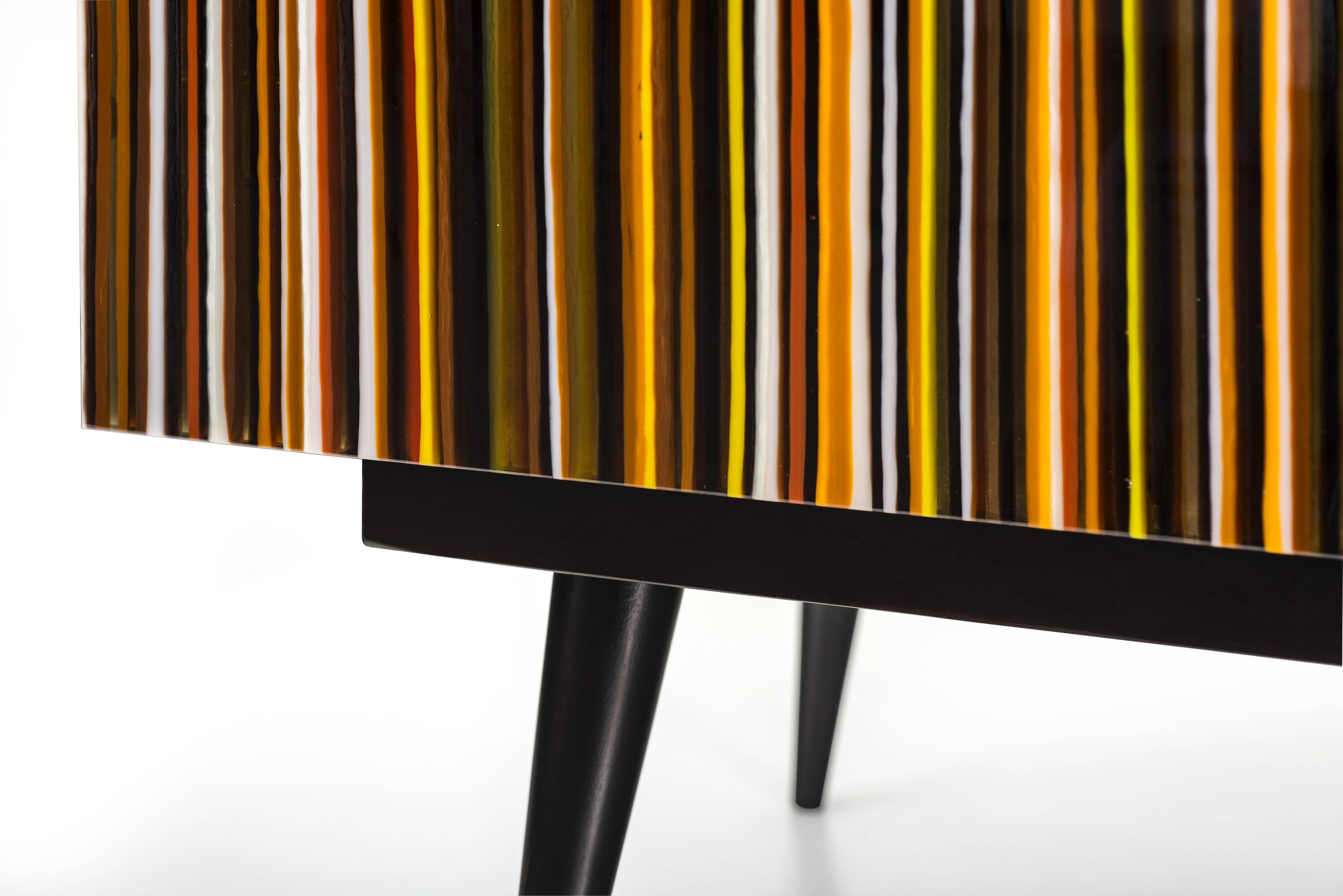 Credenza designed by Orfeo Quagliata in collaboration with Taracea Furniture. An object of fused glass created with the exclusive barcode technique. The Buff-Heyyy´s retro design mixed with designer's exceptional glass expertise put together a