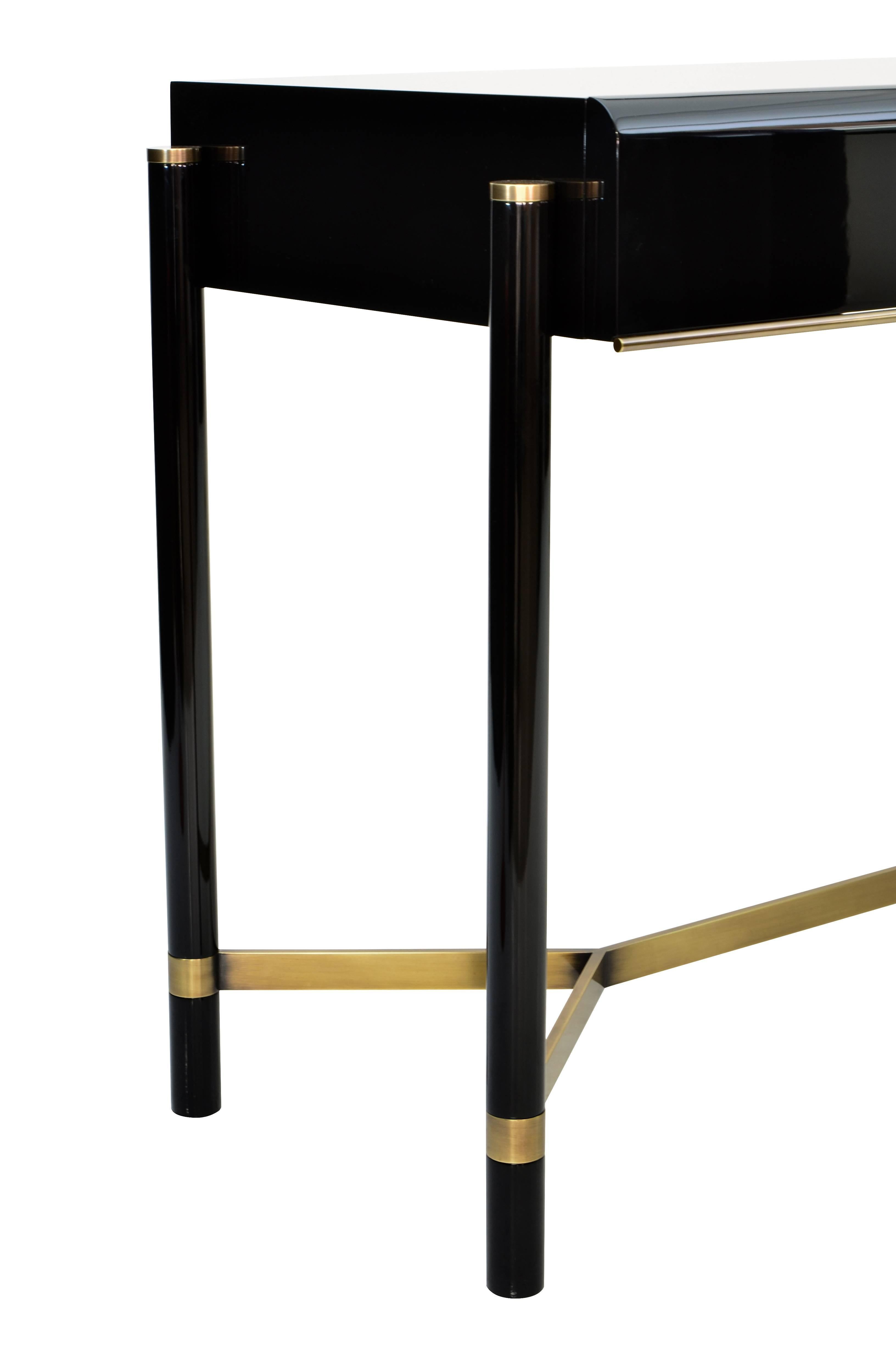 This console table draws inspiration from the 1970s and represents an elegant combination of imbuia hardwood and brass.

Legs in solid wood, veneered or lacquer. Details in solid brass

Finishing: Polyurethane varnish or lacquer, matte, medium