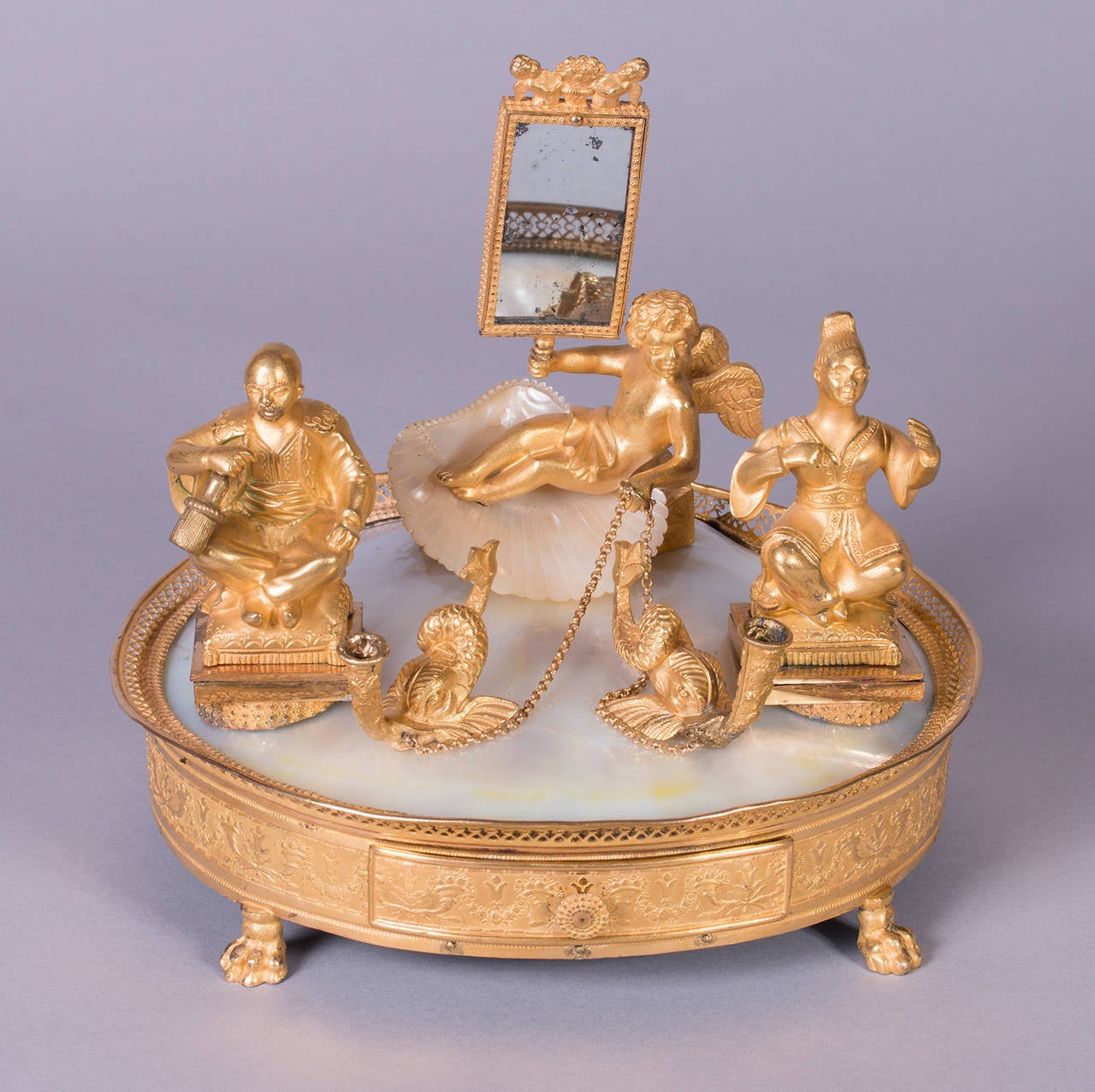 Swiss musical mechanism, signed „Aliberto [?] 33“, with two melodies (selectable), fire gilded brass with mother of pearl and a small mirror. 
Francois Alibert made musical boxes between 1800 and 1857(?) in Paris (10 rue J.J. Rousseau).