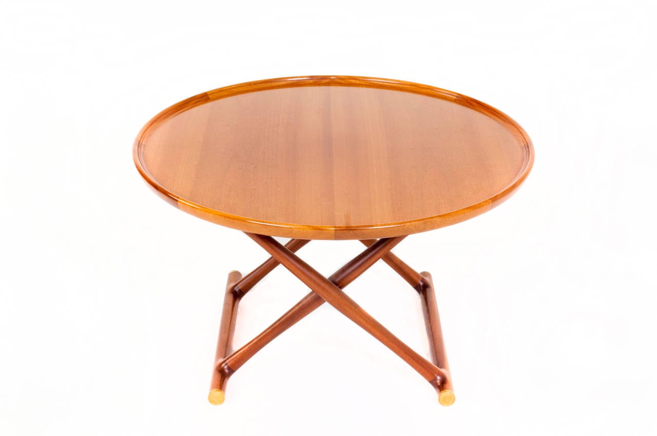 Mogens Lassen mahogany coffee table, 'Egyptian table.' Folding base with brass fittings, top with raised edge.

Designed in 1935.
Produced by Rud Rasmussen.
Measures: H. 53.5 cm. 84.5 cm.