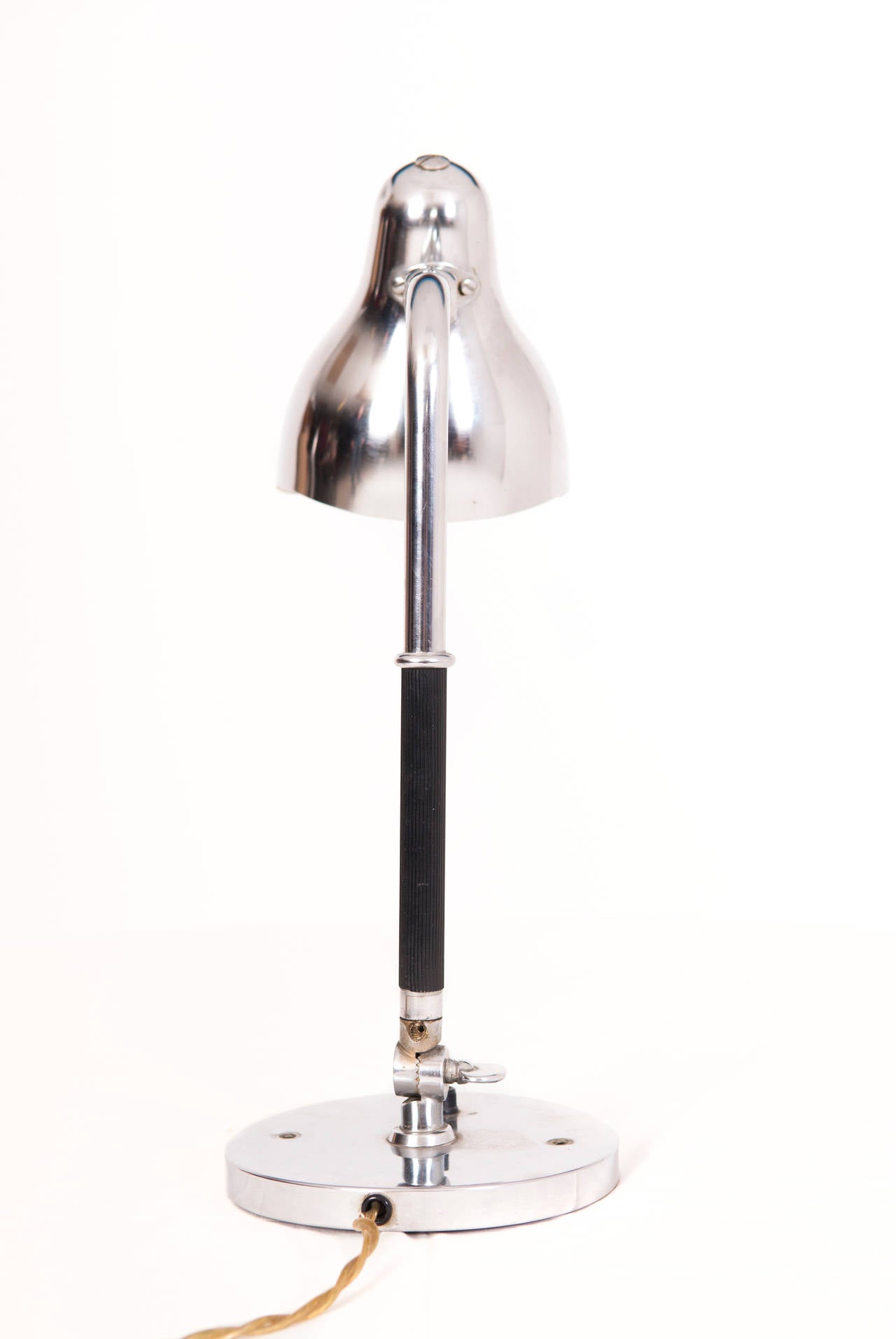 Vilhelm Lauritzen chromed metal table or wall lamp. 

Slightly curved conical shade. Stem covered with grooved black vinyl.

Designed: circa 1930.
Manufacture: Louis Poulsen.