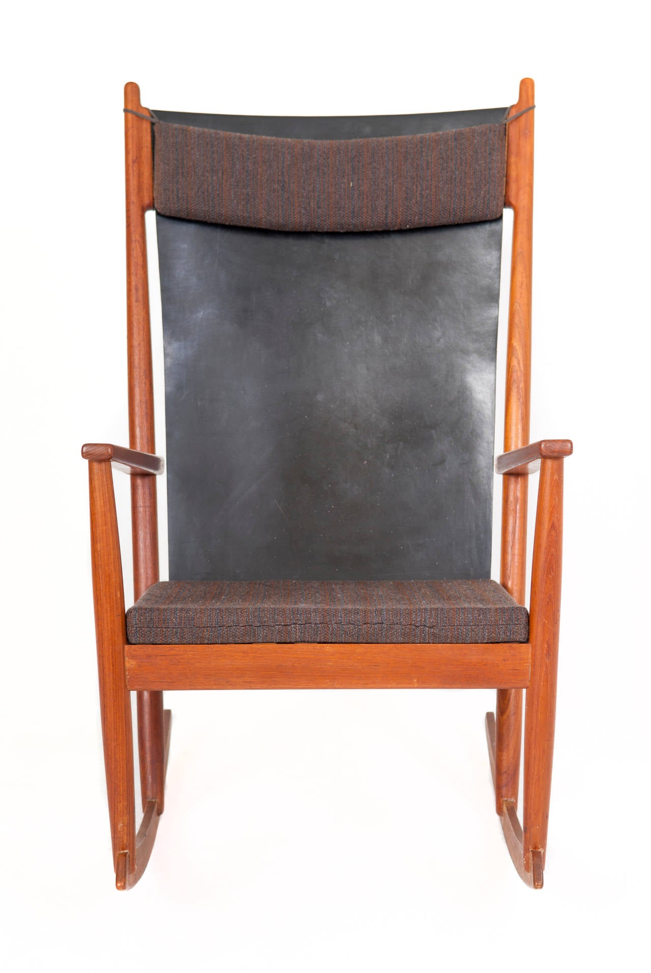 Hans Olsen Rocking chair. Made in teak and fitted with original cusin and  leather back.