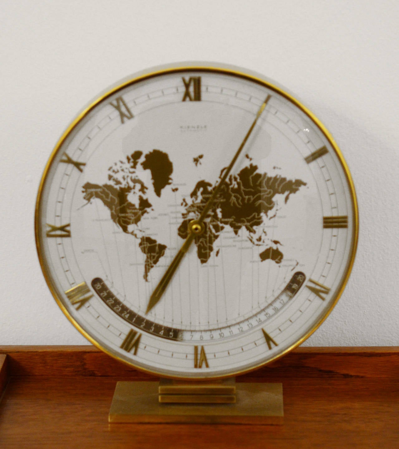 Kienzle Automatic World Timer Zone Clock. 
An exclusive big table clock from Ø 26cm wonderful clocks face with world map and world time zones, crystal glass, the heavy case & base are of solid brass. The most of Kienzle clocks were designed by