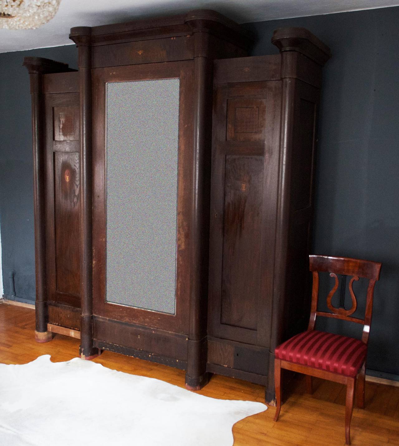 Vienna secession wardrobe still unrestored with small inlays made from different kind of veneer.
This wardrobe consist of 3 parts (doors) on the middle door is a large mirror with facet cut (50x156cm) below the doors are three drawers. 
the frame