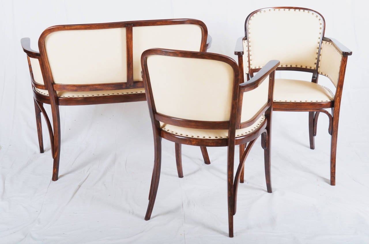 Vienna Secession Thonet Suite Catalog Number 6278.
Bentwood set consisting of a settee and 2 arm chairs.
The Suite is restored with traditional methods.
Wood is dark nut stained and covered in beige leather.
(exact dimensions on request)