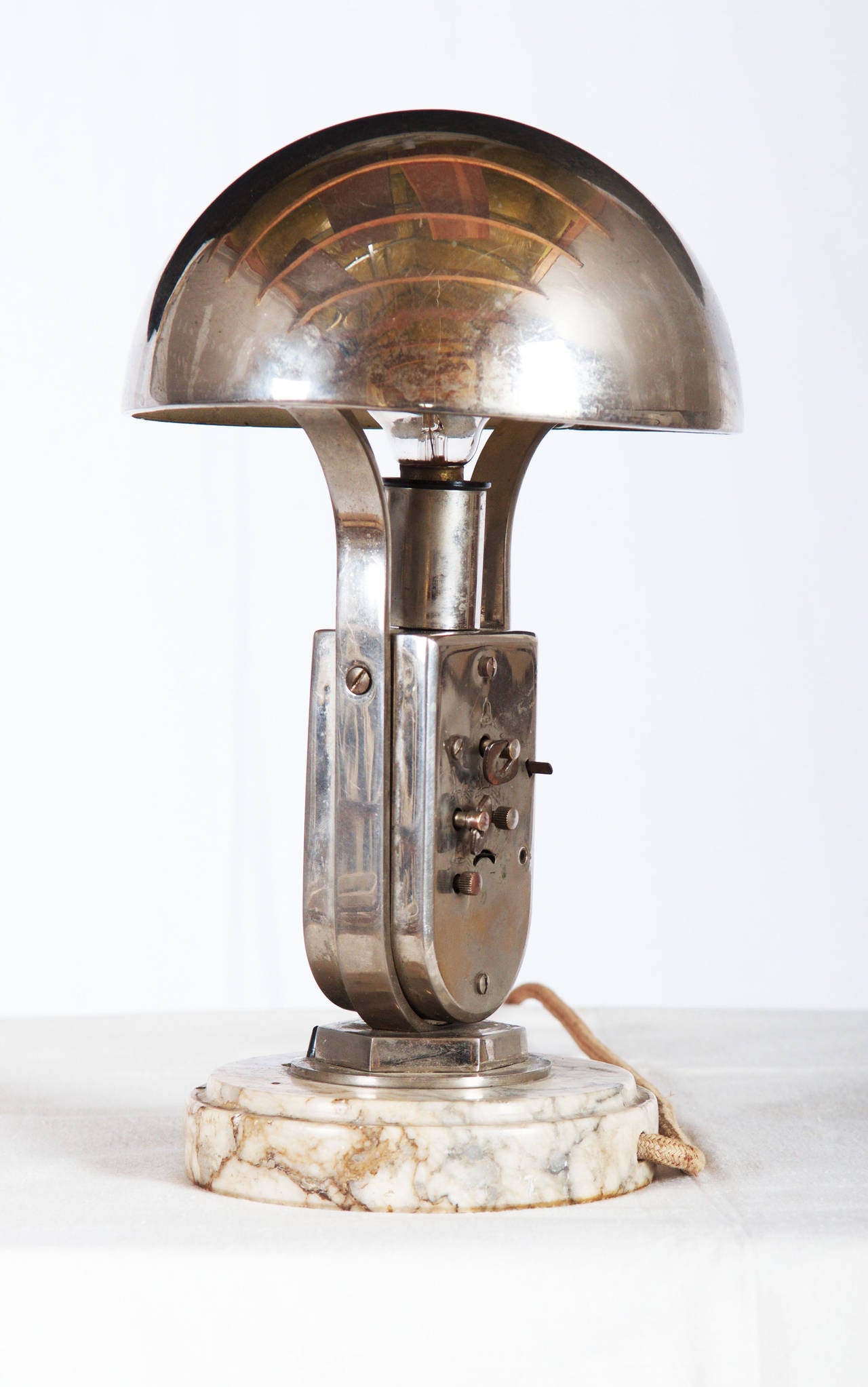 Art Deco Mofem Table Lamp with Integrated Alarm Clock Nickel-Plated 
Hungary about 1930s table lamp with integrated alarm clock. 
Metal construction nickel-plated with very nice marble base and an adjustable hemispheric lampshade. 
Fully working.