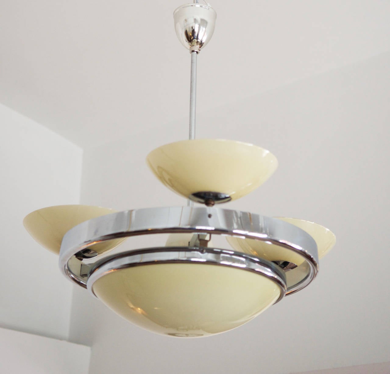 Art Deco Streamline chandelier from circa 1930s.
Chrom-plated steel, opaline glass, new electric with two circuits.
 