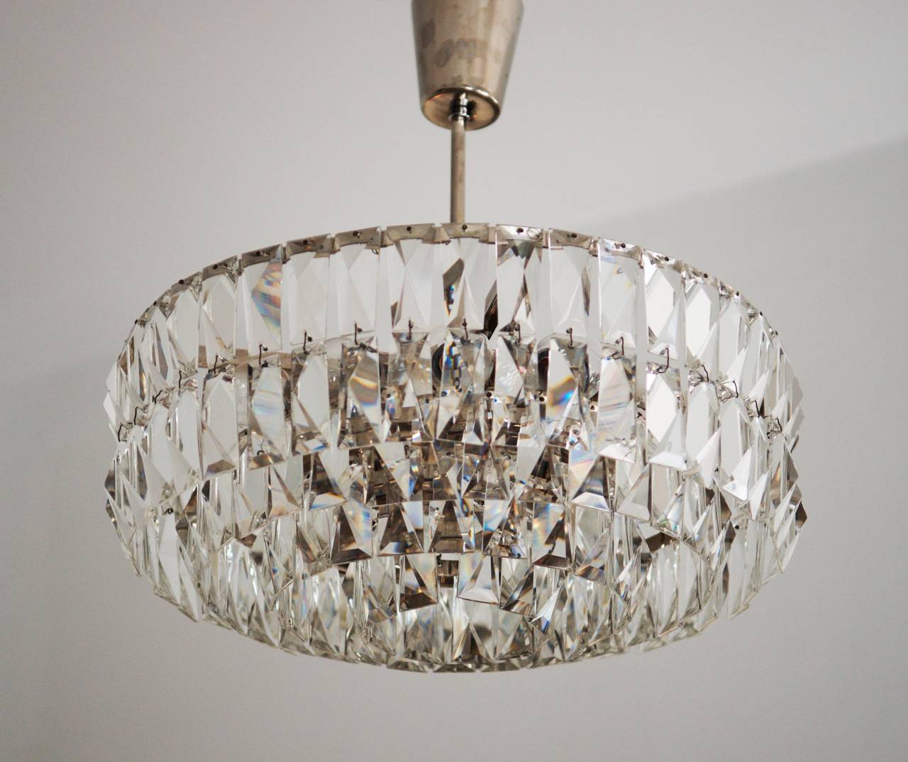 Impressive and stunning crystal chandelier from about 1960s by Bakalowits & Söhne.
Bras construction nickel-plated with four ring with hand-cut crystals in the  rombform.
Electric with 12 lights sources with two circuits.
Dimensions:  diameter