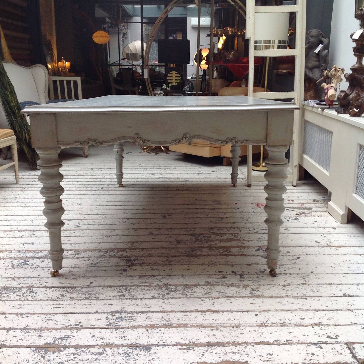 Perfect as both a desk and a dining table, this Swedish table from the mid-1800s is a great addition to any household. With simple yet sophisticated carved designs on both the base and the legs of the table, the pale color of the piece showcases the