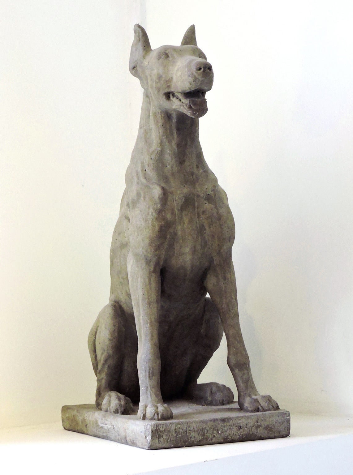Pair of whimsical cast stone dogs, circa 1900-1920.
Height: 33 inches, depth: 21 1/2 inches, width: 12 inches.
Wonderful for garden statuary or for flanking an entryway.