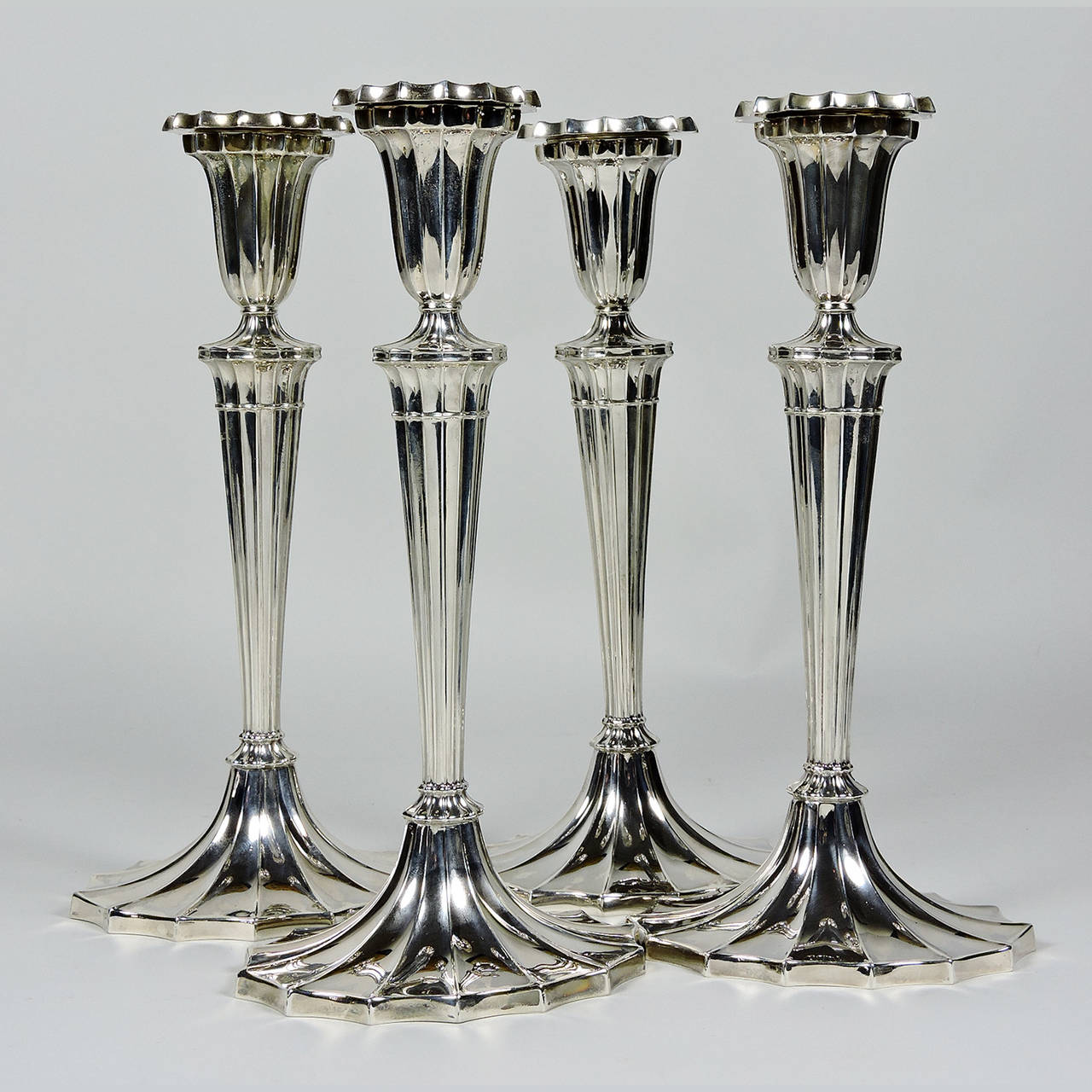Set of four Gorham silver neoclassical style candlesticks, late 19th century; with fluted and tapered shafts, beaded bobeche and oval base. Marked Gorham, sterling, #231, two date stamped 1894 and two stamped 1895. Approximate total weight: 63.94 oz.