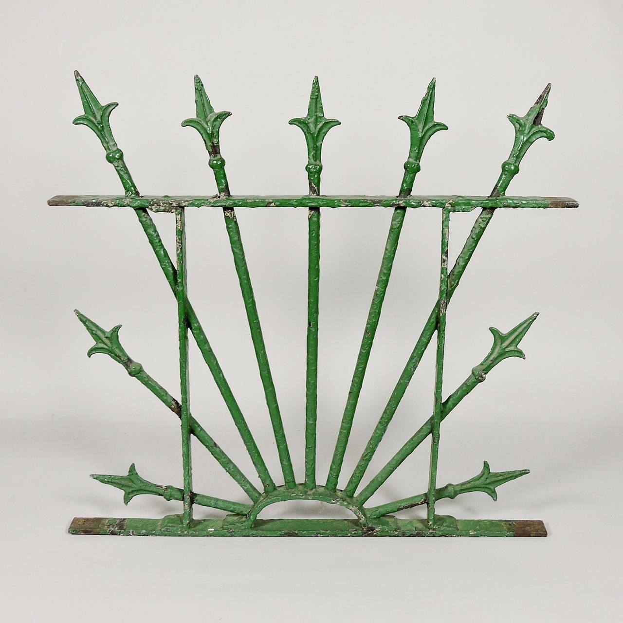 Pair of green painted wrought iron architectural elements. Originally designed and used as window grates, with Fleur-de-lis tips, the combination of color and dramatic structure make for great wall hangings.
Dimensions: 23.5 x 25 x 1.5 inches.