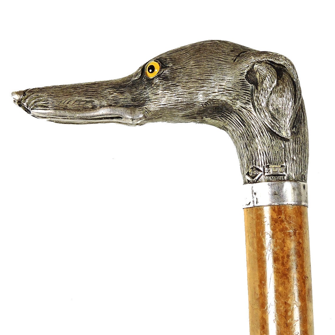 Howell & Co. English silver whippet form walking stick handle, circa 1914-1915, bearing silver marks for Jonathan Howell, London. Fanciful whippet head with glass eyes mounted on a short wood post. 
Measures: Silver: 4 x 2 x 1 1/4 inches, overall: