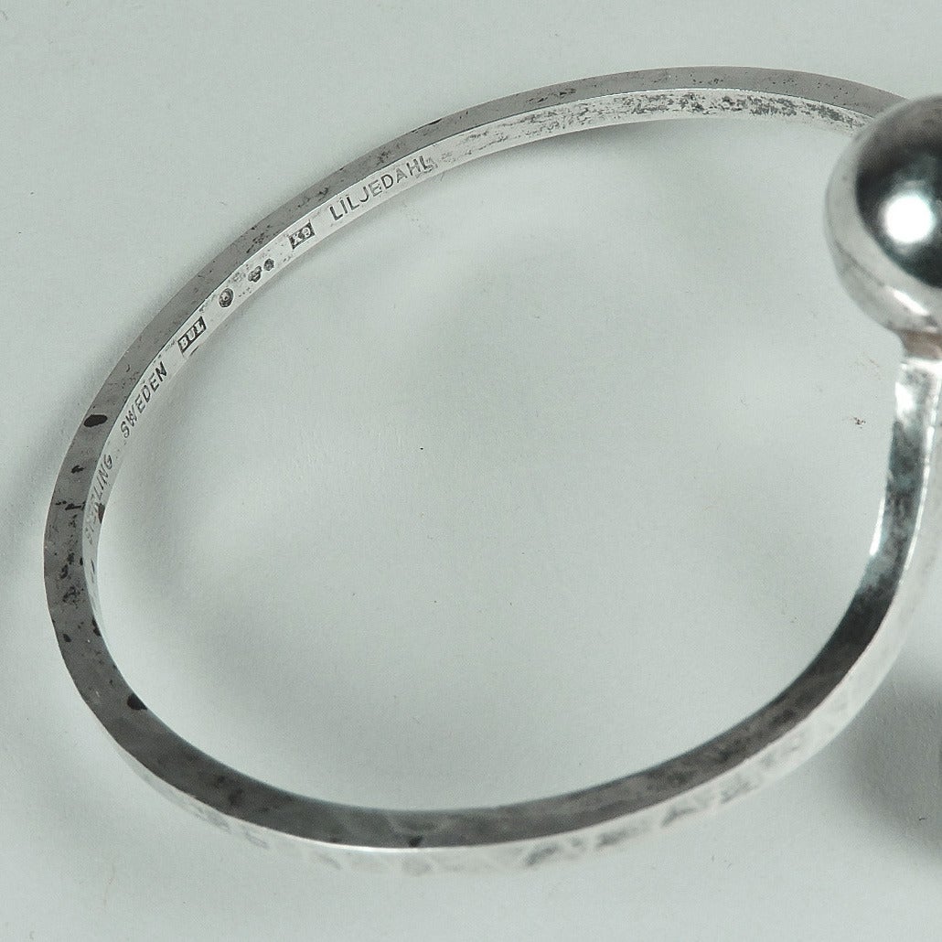 Rare sterling silver armband by Swedish modernist Bengt Liljedahl (b. 1932).
Double spheres on a hand-hammered band, marked 