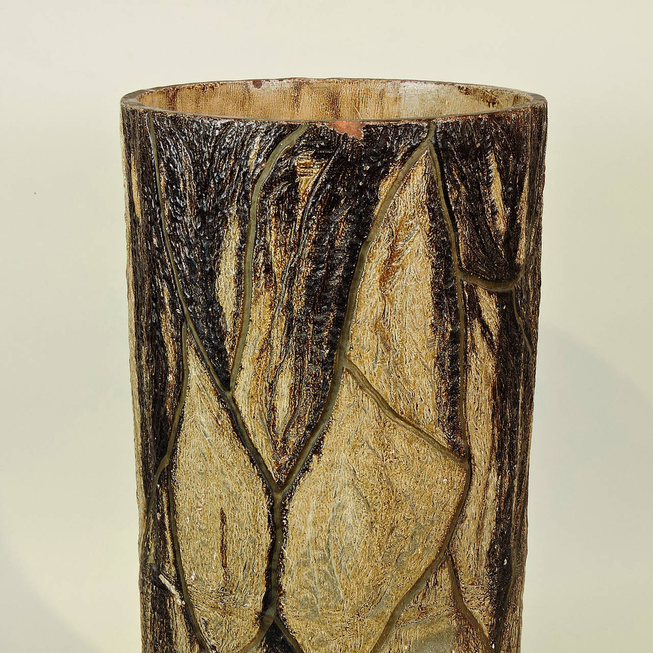 Faux bois painted terracotta umbrella stand, possibly English, late 19th century. Cylindrical form with naturally realistic modeled tree bark relief.
Measures: Height: 20 1/4 inches, diameter: 9 inches.