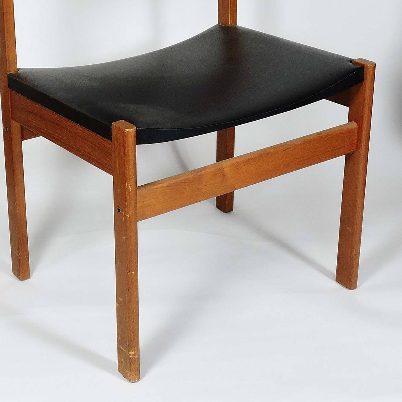 Set of four Danish Mid-Century Modern teak and leather dining chairs, by G. P. Farum, Denmark. Label on underside marked 