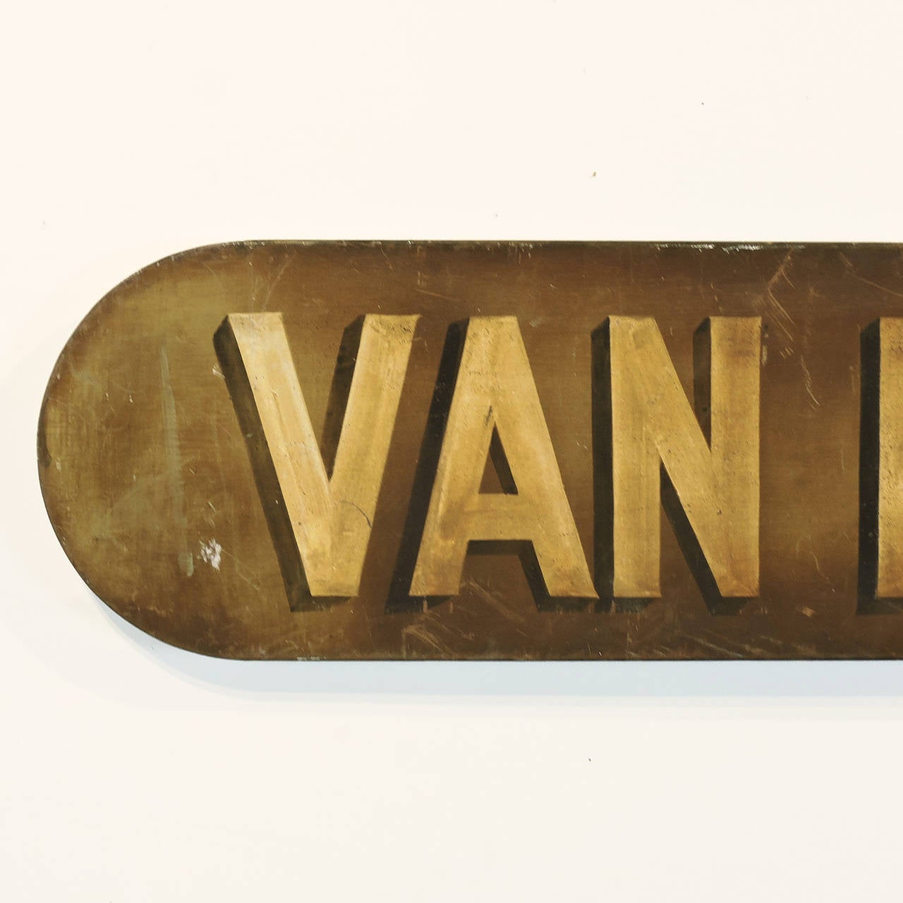 An early 20th century painted metal advertising sign for Van Heusen shirts. Measures: Length 59 1/4 inches.

The history of the American Van Heusen company began in 1881 in the Appalachian coal country of Pennsylvania, where Moses Phillips and his