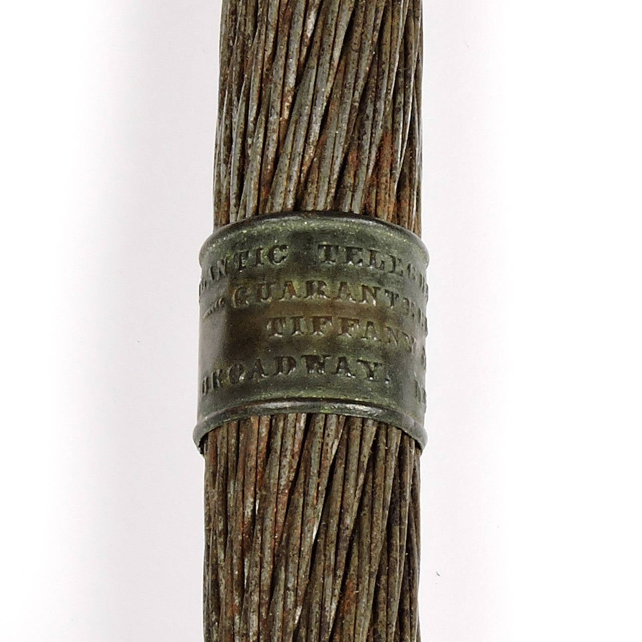An original section of the first transatlantic cable laid by Cyrus W. Field. Brass caps at both ends with a center band that reads 