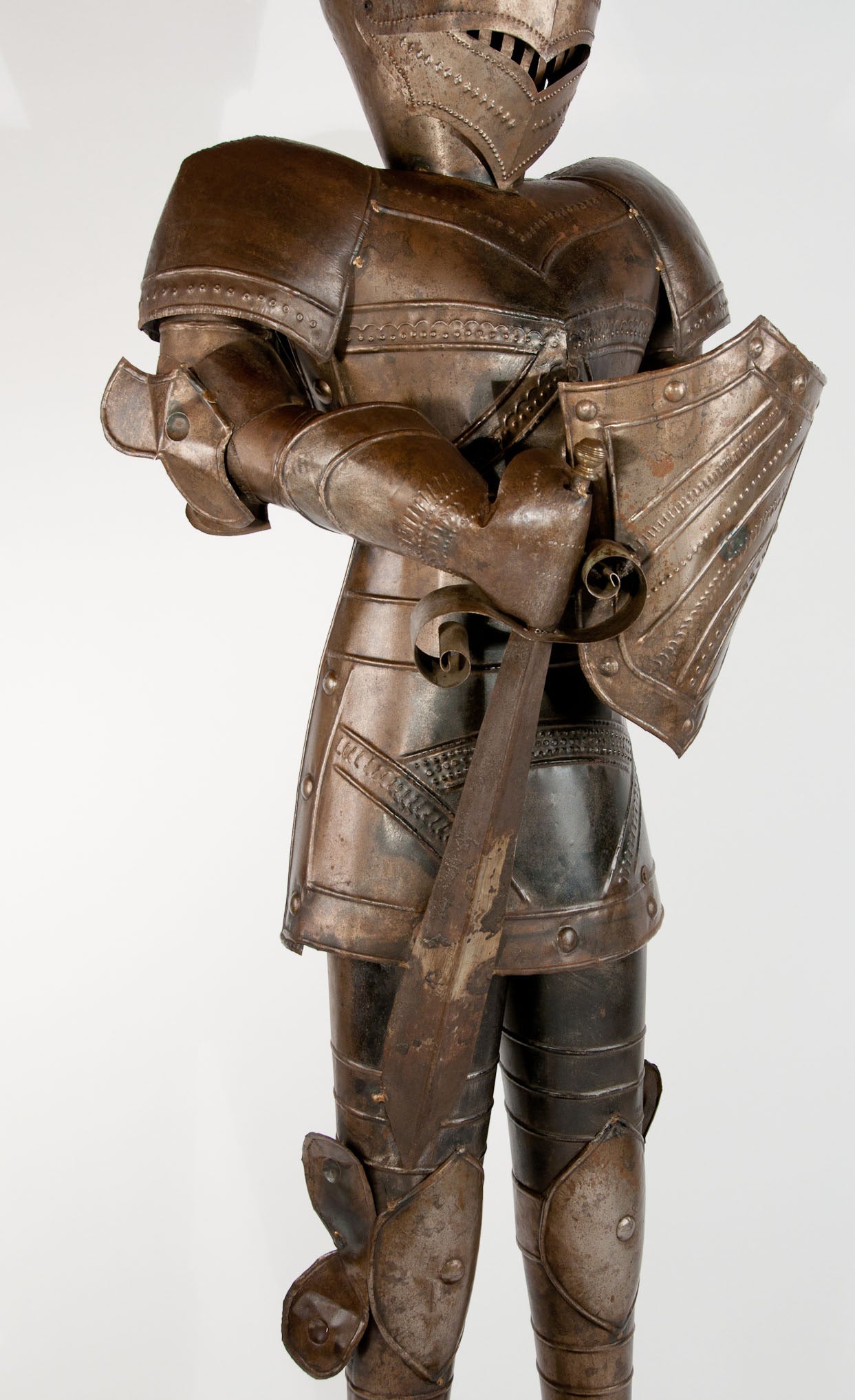 A Delightful and slightly larger than life! tin statue of a knight in armour. Standing at a impressive 7 foot 2 inches in total this antique suit of armour constructed from tin has been made to the highest quality. An impressive item to make the