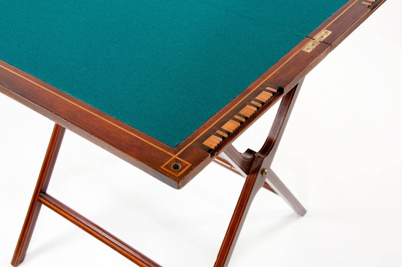 A fine quality Edwardian mahogany inlaid games table. This folding Edwardian games table is made of the highest quality by the manufactures 