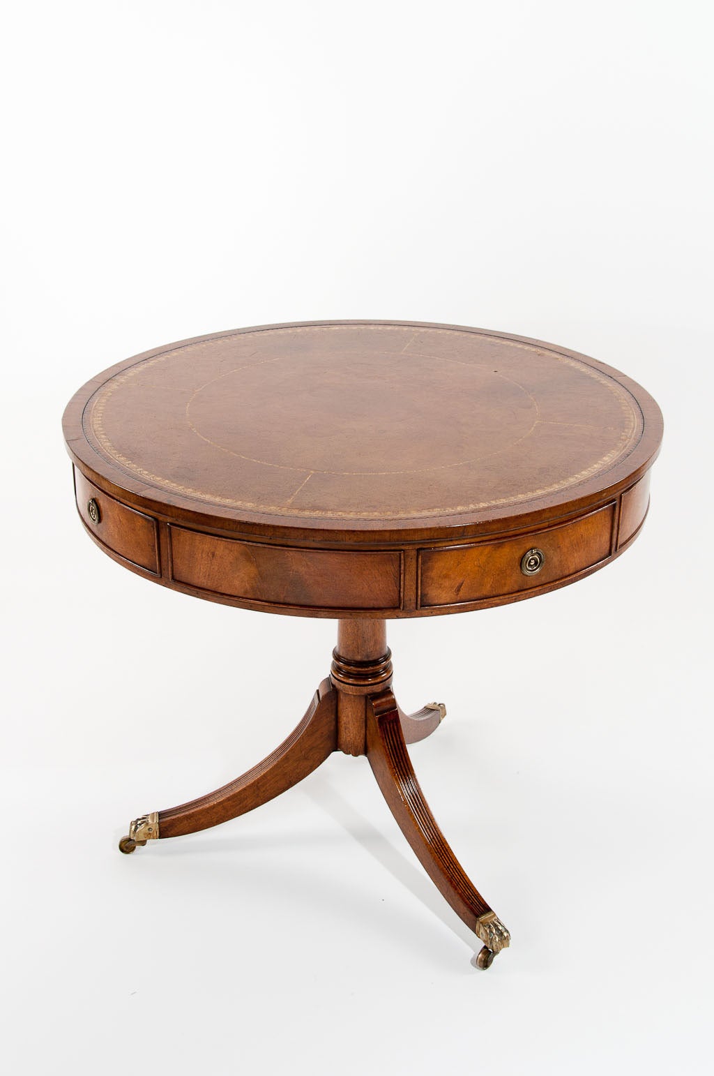 A very fine quality mahogany revolving drum table with original leather top. This lovely quality drum table has a fine crossbanded edge with inset tan and gold tooled leather having four oak lined drawers within it's frieze. The top being able to