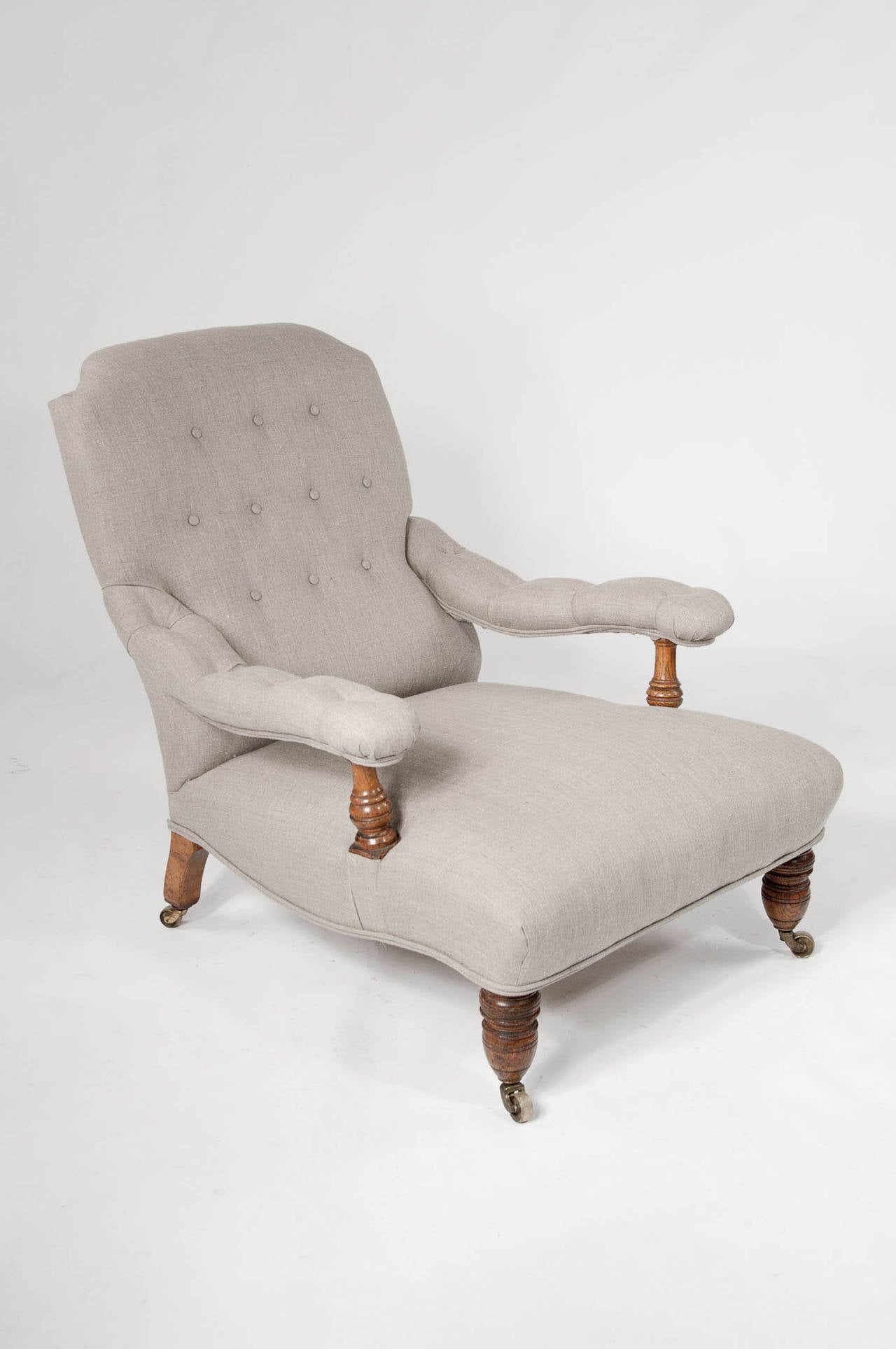 Quality late 19th Century Oak English country house armchair in the manner of Howard & Son. This super comfortable light honey oak armchair dating to circa 1880 is typical of the famous Howard and Sons style with the low deep seat having gently