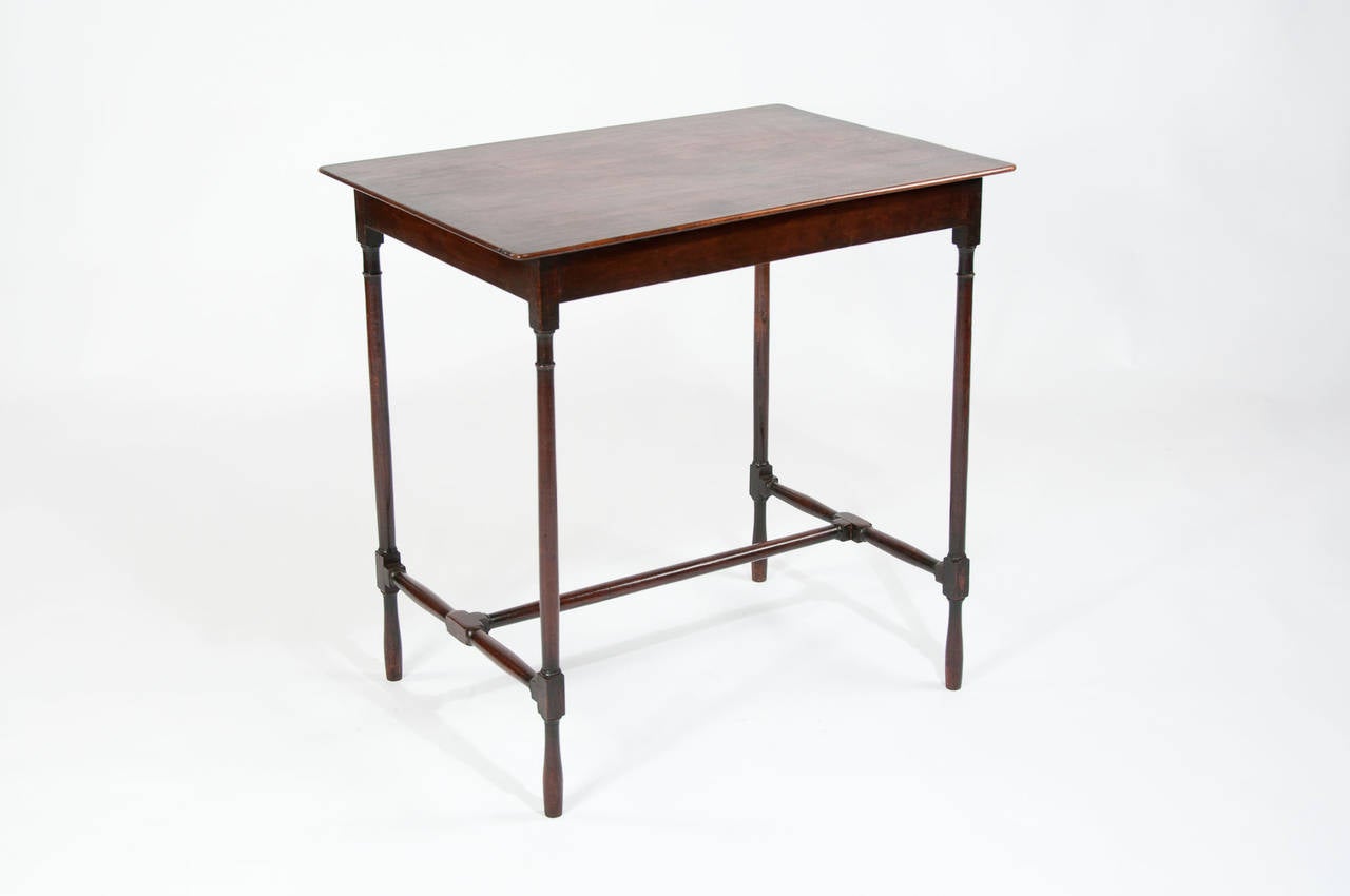 An antique Georgian mahogany side table with H-stretcher base. In beautiful original condition this Georgian table dating to the late 18th-early 19th century has lovely slender ring turned legs untied by a H-shaped stretcher base. The timber has a