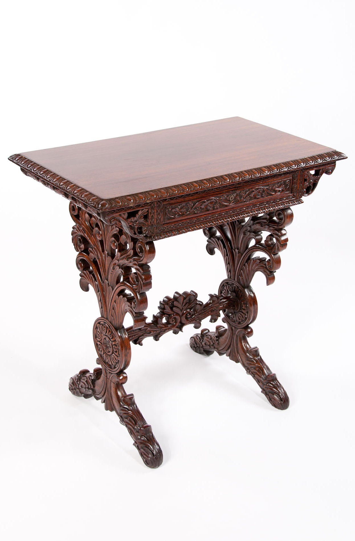 A fine quality 19th century Anglo-Indian rosewood carved side table with single drawer. Decorated profusely with Fine carving, this antique table dates to 1830s. Made from solid rosewood the table originates from India and has a central fitted