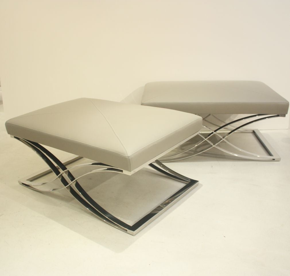 Pair of benches made by the Italian furniture design company, Cecchini. The benches have chrome bases and leather cushions that are newly upholstered in Jamie Stern Danbury Grey leather.