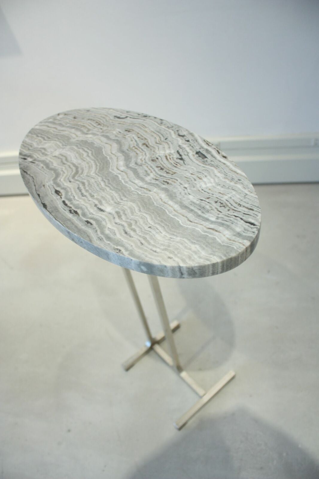 Emily Summers Studio Line - Ozzie Drink Table.  Linear Cut Onyx with a Satin Nickel base.