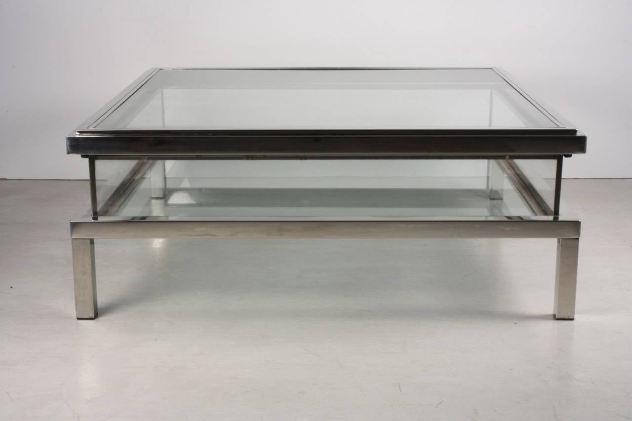 Maison Jansen Vitrine coffee table with sliding top. Maison Jansen was one of the oldest global interior design firms. They specialized in meticulous antique reproductions as well as contemporary designs of the times.
This glass and chromed steel